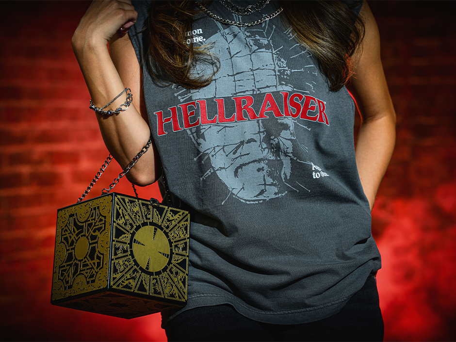 A guest poses in a Hellraiser T-Shirt and holding a Lament Configuration purse