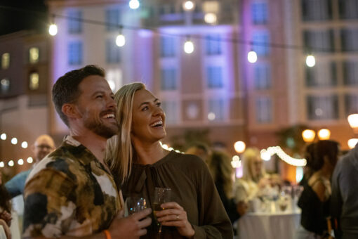 A couple smiles at the Harbor Nights event at Loews Portofino Bay Hotel