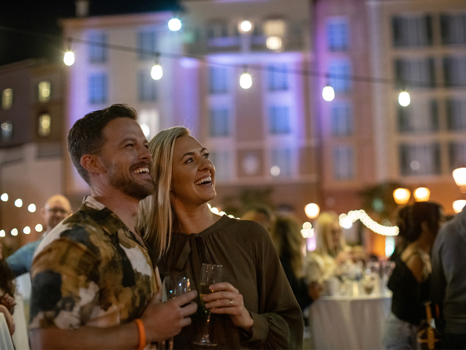 A couple smiles at the Harbor Nights event at Loews Portofino Bay Hotel
