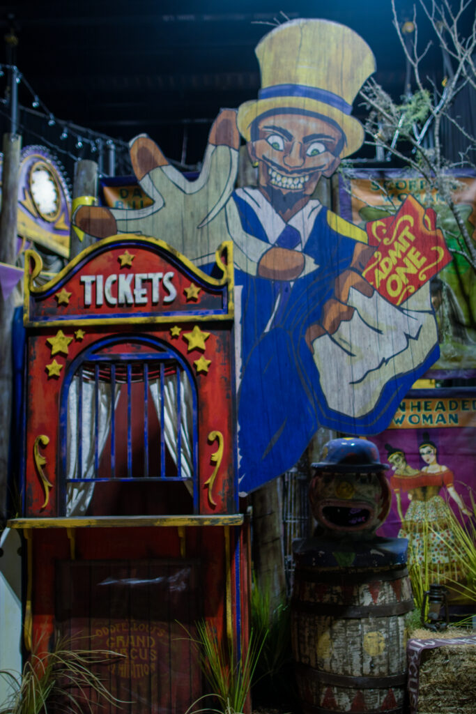 The entrance to the Jack & Oddfellow: Chaos & Control house at Halloween Horror Nights 2026. A cut out of Dr. Oddfellow reaches toward the viewer.