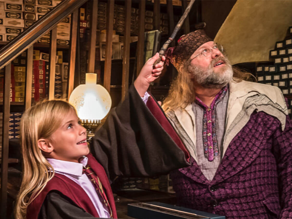 A girl casts spells with her wand in Ollivanders Wand Shop