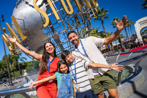 A family poses in front of the globe at Universal Studios Hollywood.
