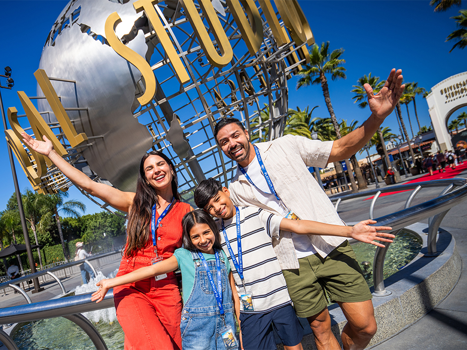 A family poses in front of the globe at Universal Studios Hollywood.