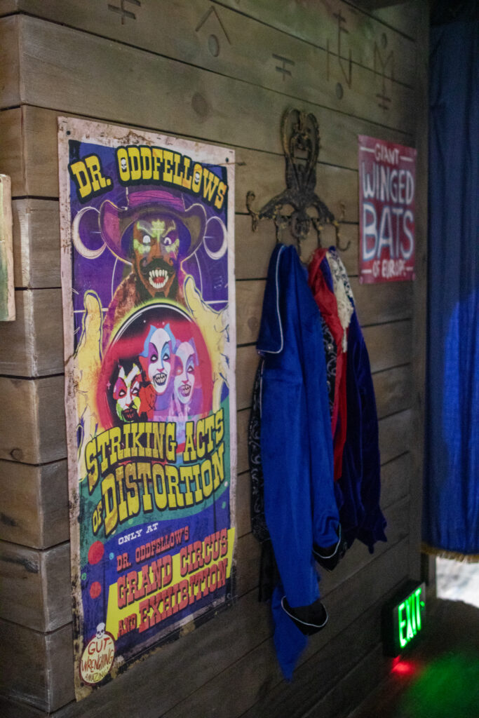 A wall at Jack & Oddfellow: Chaos & Control house at Halloween Horror Nights 2026 with a carnival poster