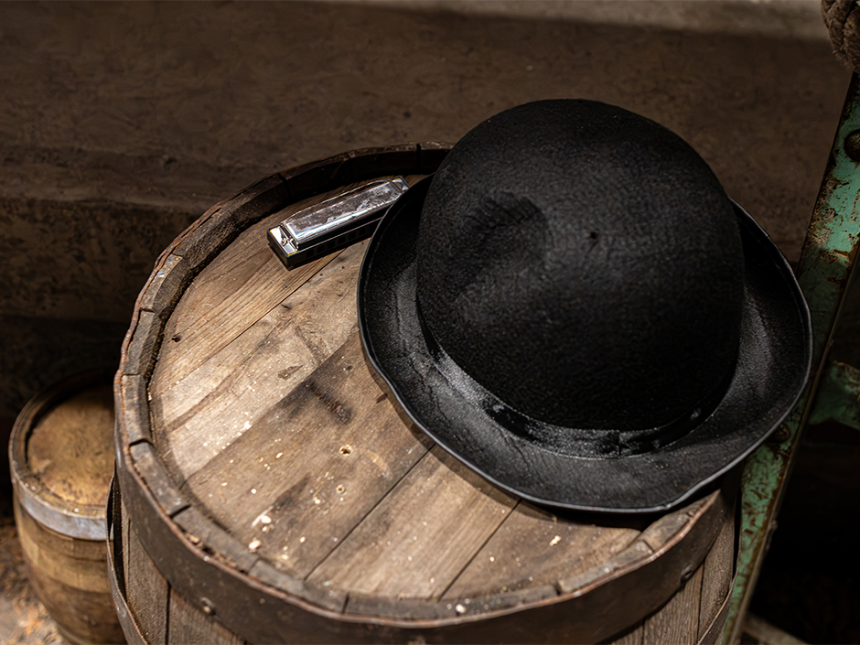 Image of a top hat and harmonica in the Sinners haunted house at HHN at Universal Orlando Resort.
