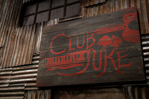 Exterior close-up of the Club Juke sign at the Sinners haunted house at Halloween Horror Nights at Universal Orlando Resort.