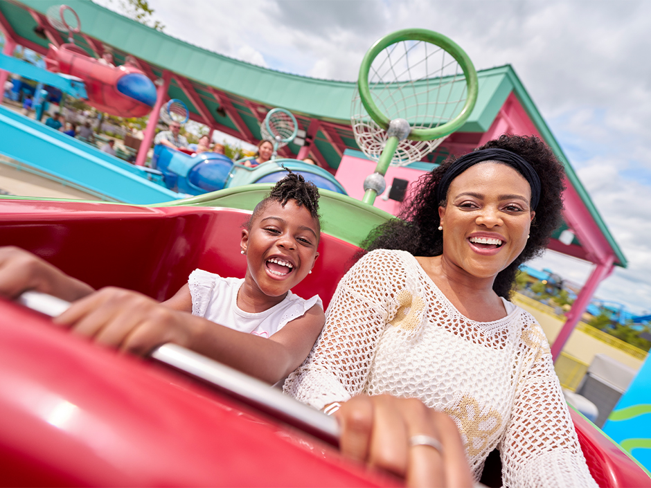 A mother and daughter have fun on a ride at Universal Kids Resort together.