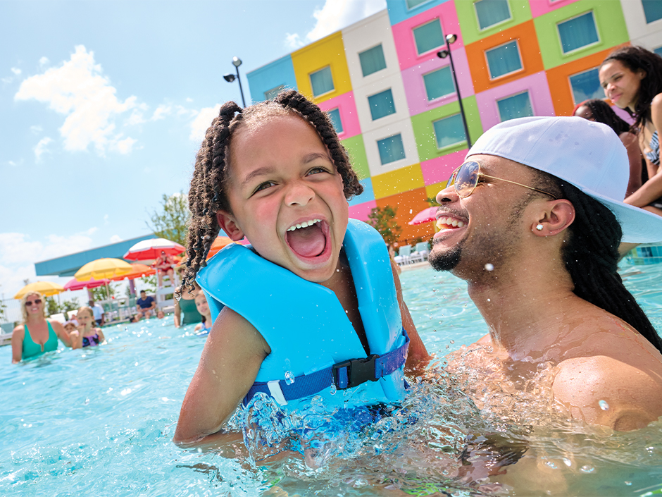 A father and daughter play in the pool at Universal Kids Resort Hotel.