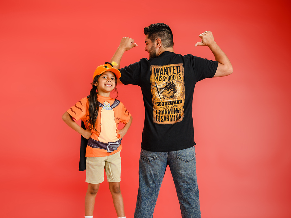 A man and child are wearing Puss in Boots merchandise