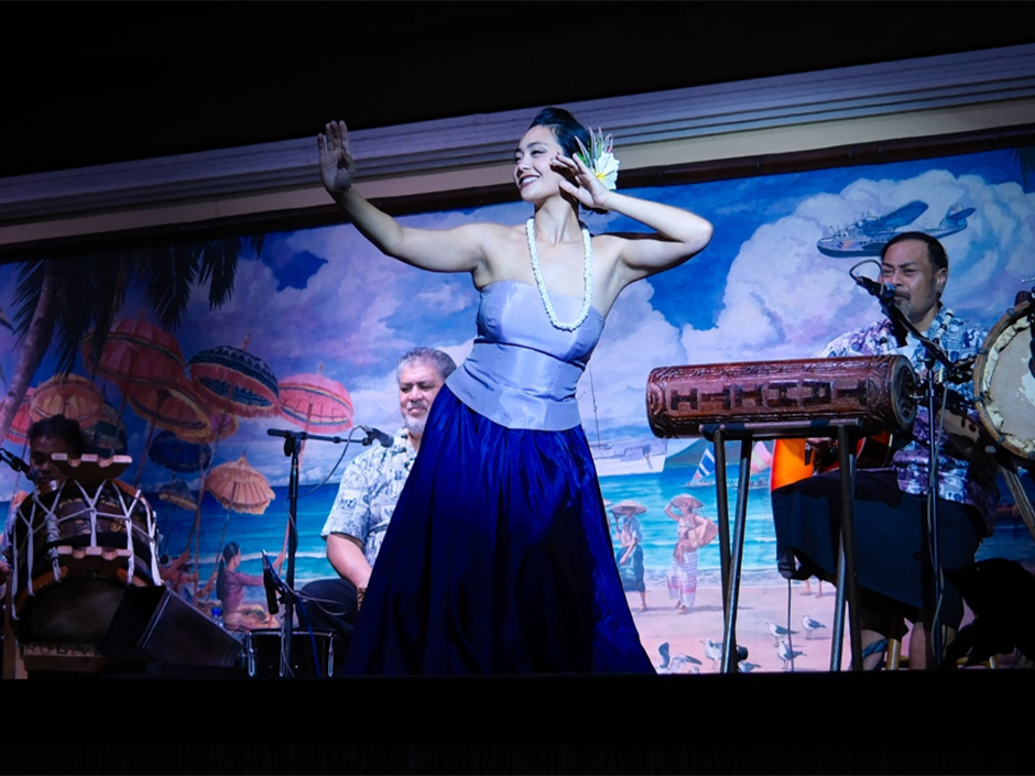 A performer dances onstage during Wantilan Luau at Loews Royal Pacific Resort