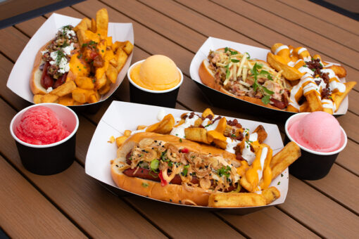 Three hot dogs available from Fat One's at Universal CityWalk alongside three flavors of Italian ice: cherry, mango, and cotton candy