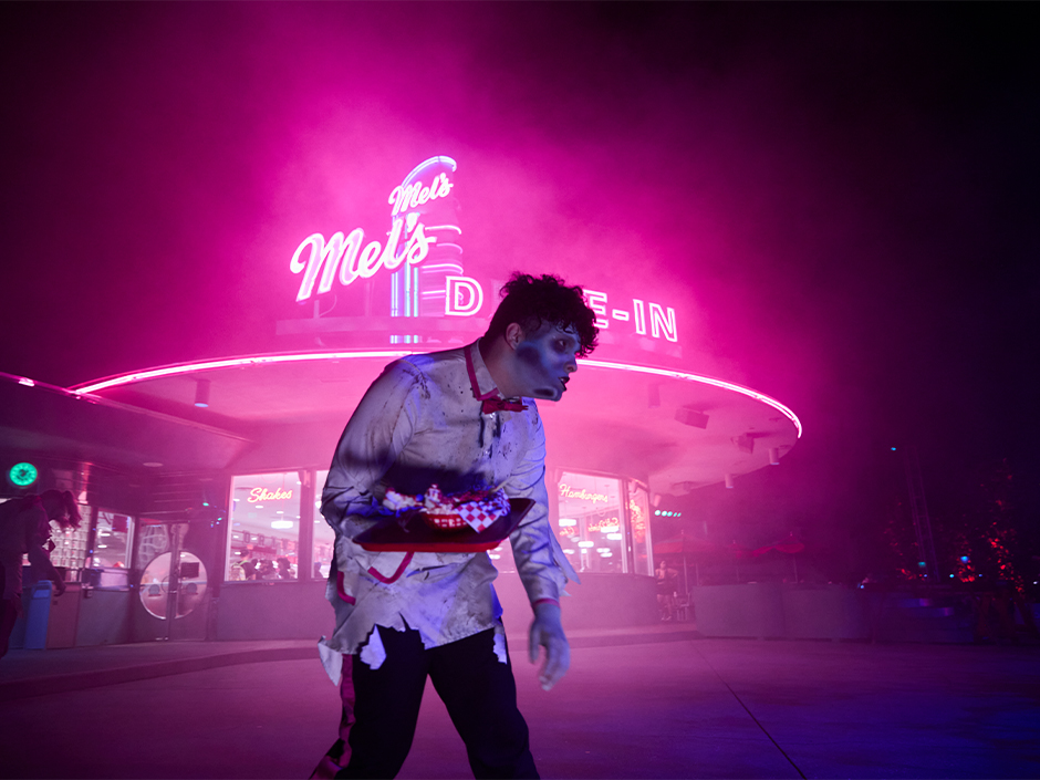 A zombie carhop lurks outside of Mel's Drive-In at Universal Halloween Horror Nights