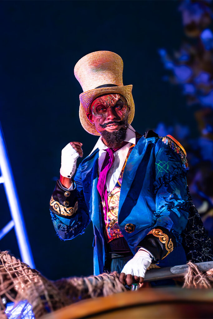 Dr. Oddfellow poses for the camera from his podium in the Infernal Carnival of Nightmares at HHN