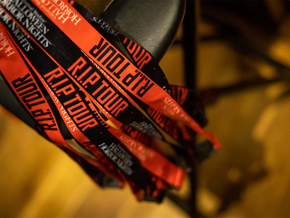 Several R.I.P Tour lanyards hanging next to each other from a table