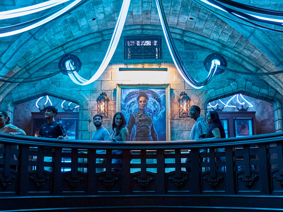 A portrait of Victoria Frankenstein looms over the crowd walking through Monsters Unchained: The Frankenstein Experiment