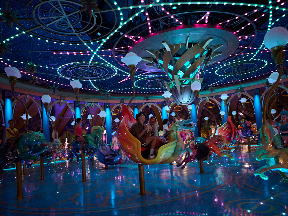 Guests ride Constellation Carousel in Epic Universe at night