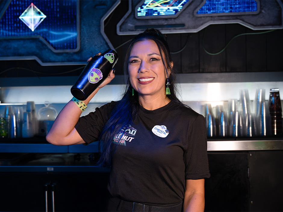 A bartender poses inside Dead Coconut Club
