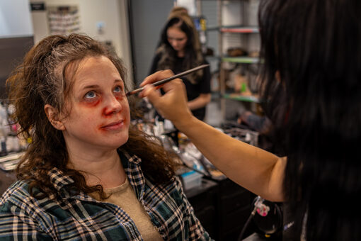 A scare actor gets her makeup done at Universal Horror Unleashed.