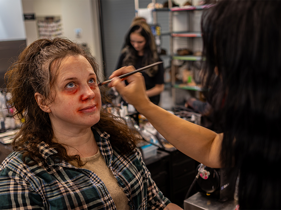A scare actor gets her makeup done at Universal Horror Unleashed.