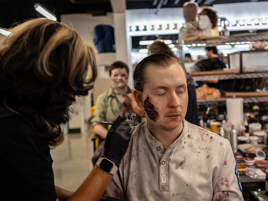 A scare actor gets his makeup done at Universal Horror Unleashed.