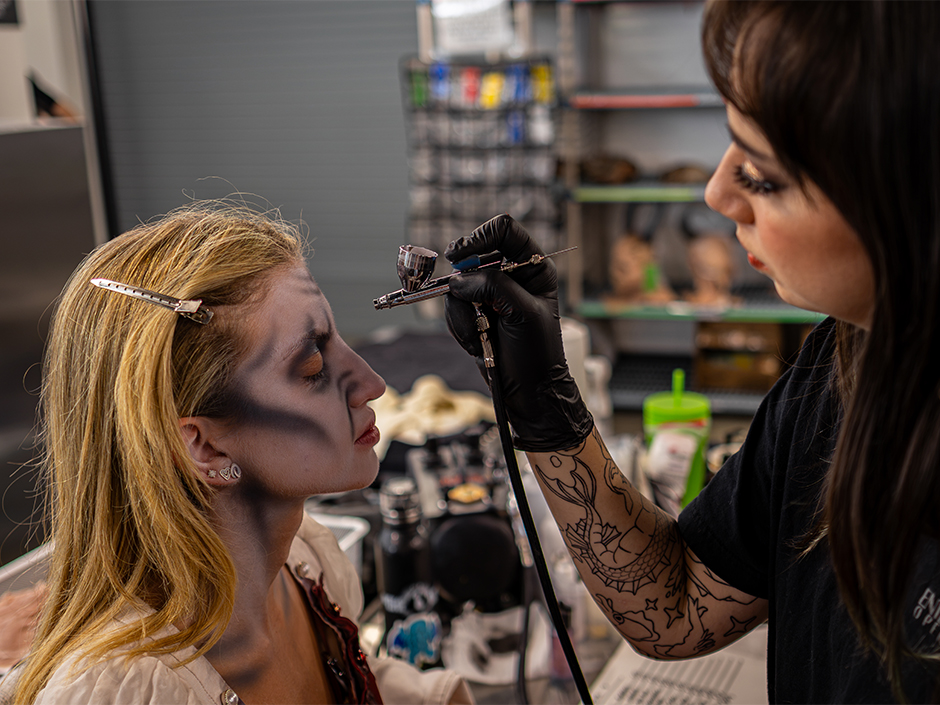 A scare actor gets her makeup done at Universal Horror Unleashed.