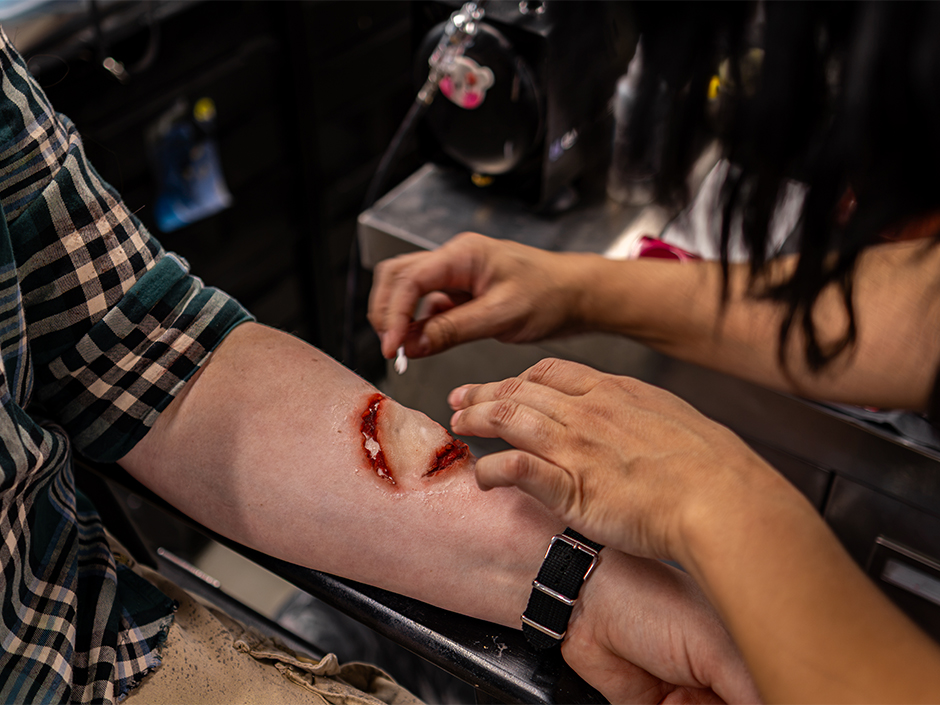 A scare actor gets her makeup done at Universal Horror Unleashed.